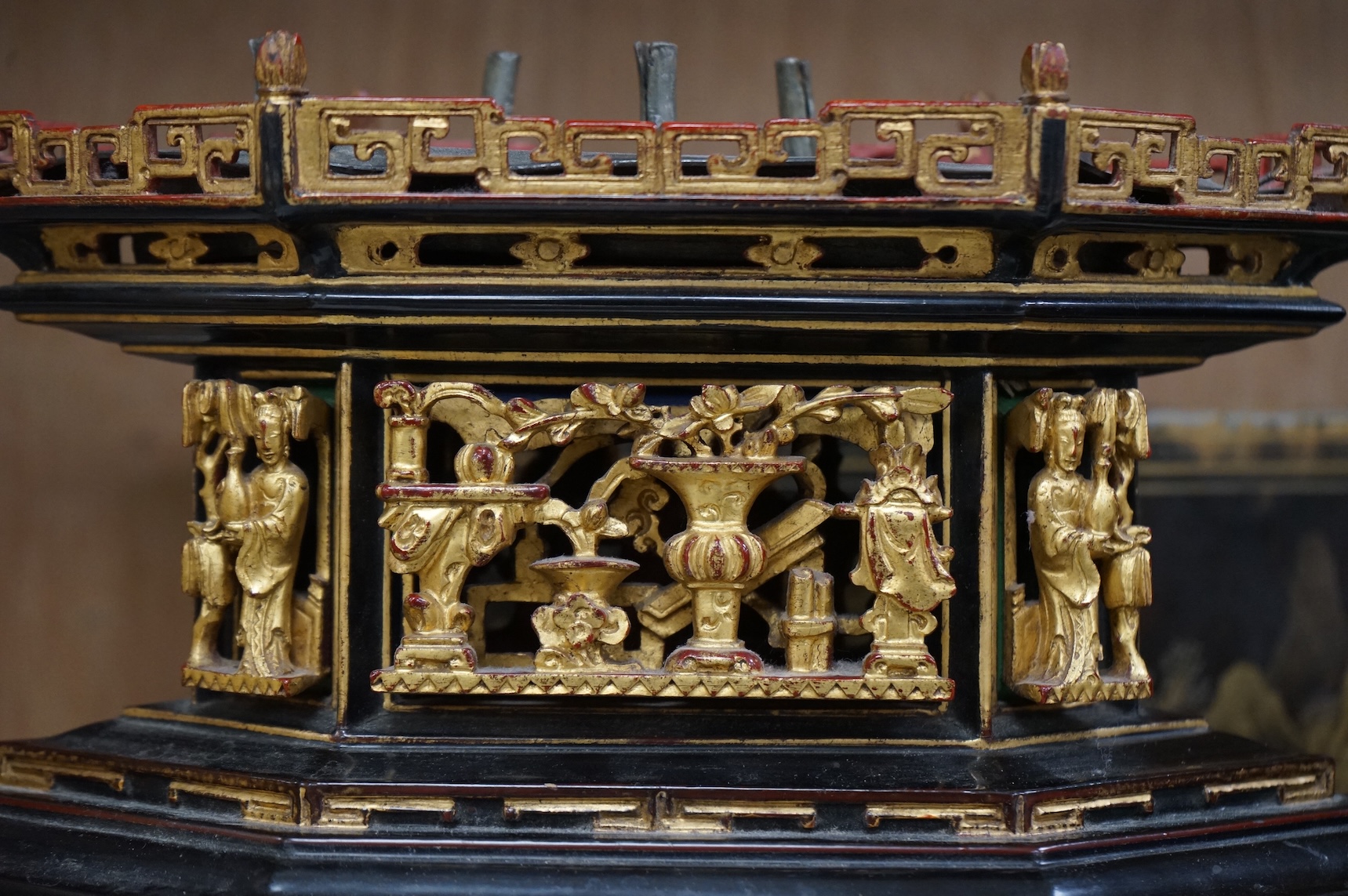 A Chinese lacquered and carved wood temple ornament, 26.5cm high, 32cm widest on base.